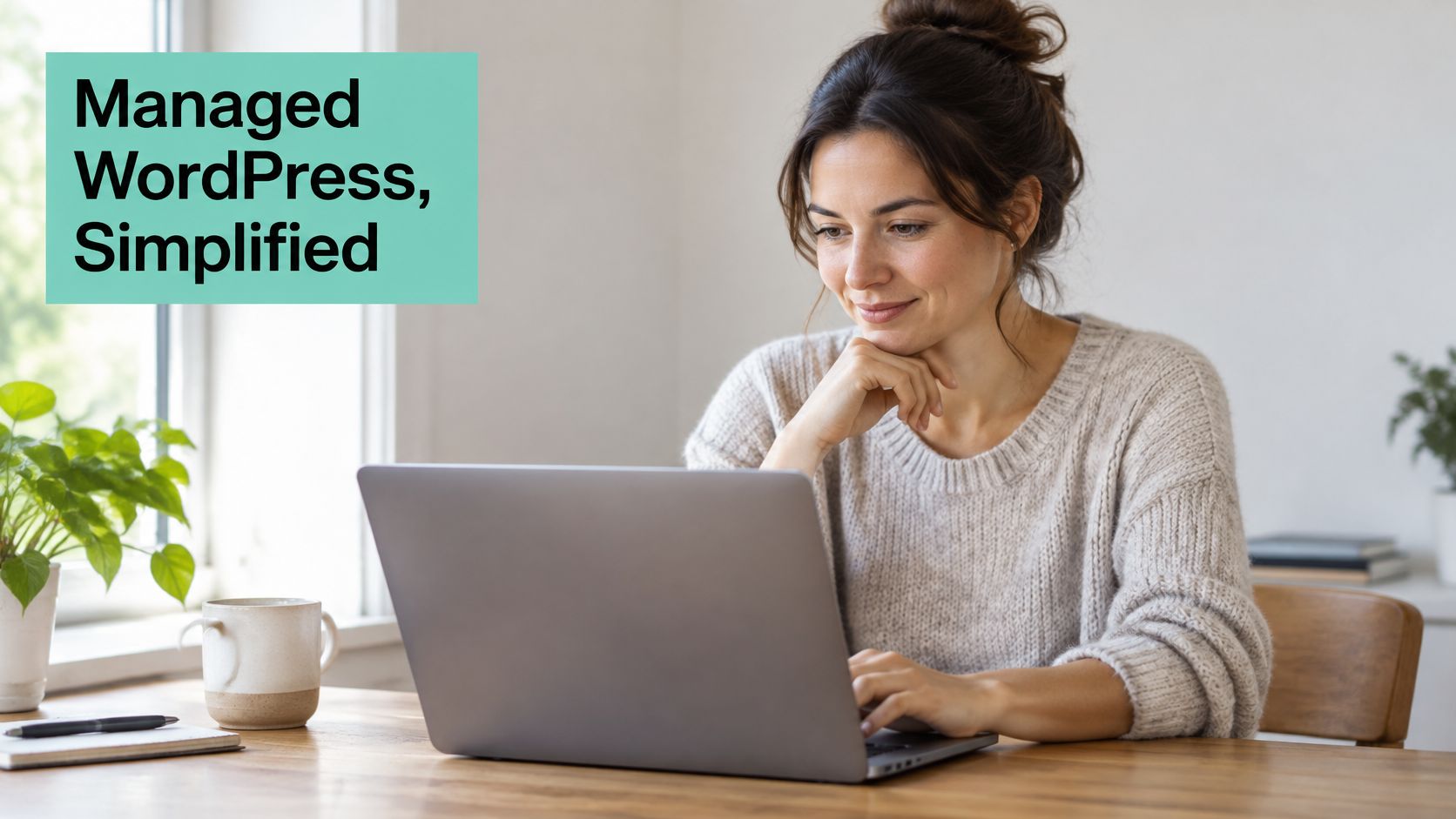 What Is Managed WordPress Hosting? a Plain-English Guide 2 A woman working on her laptop in a bright home office, smiling at the screen while typing.